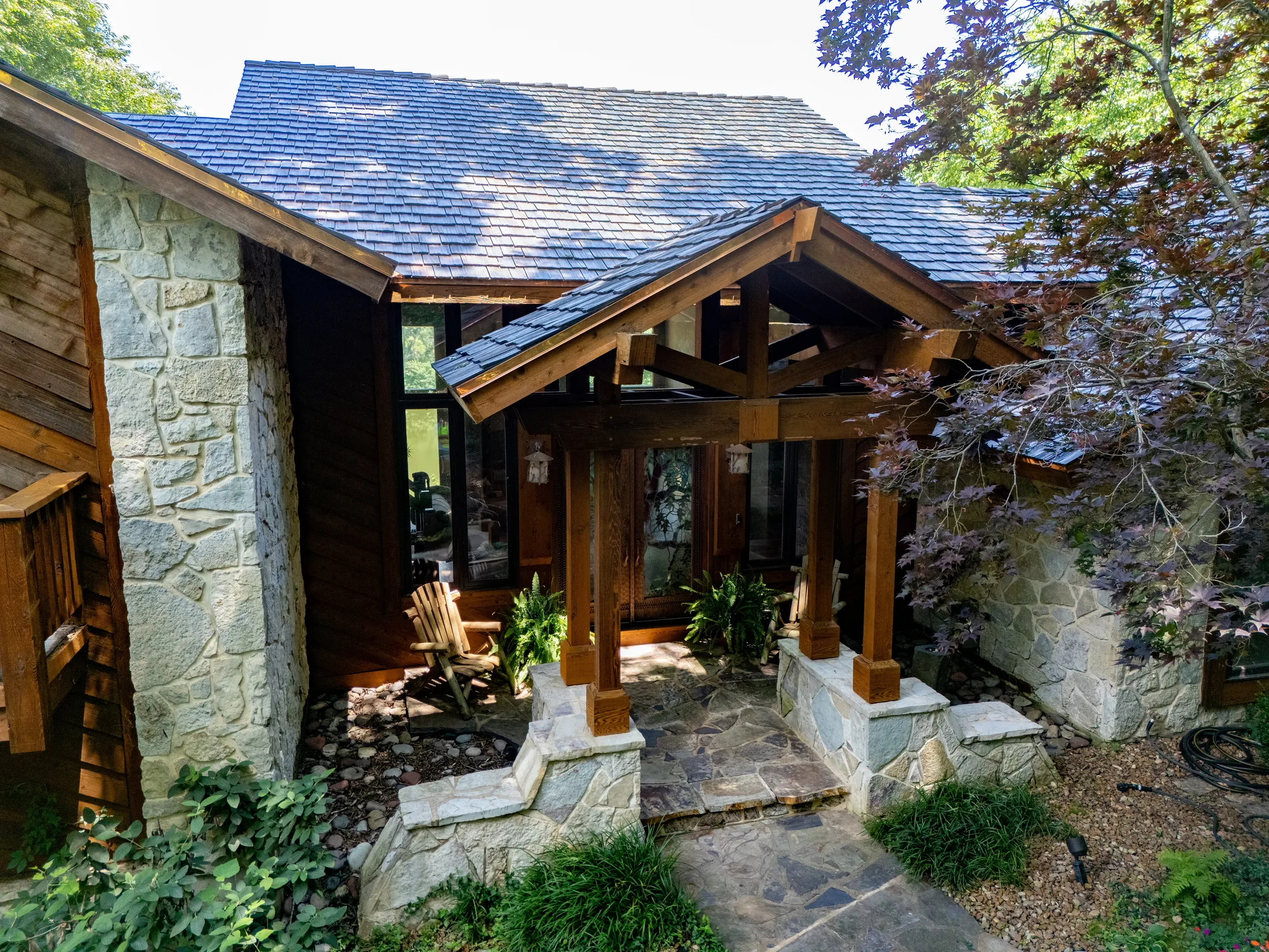Shake slopes meeting the stone entry columns of the lodge