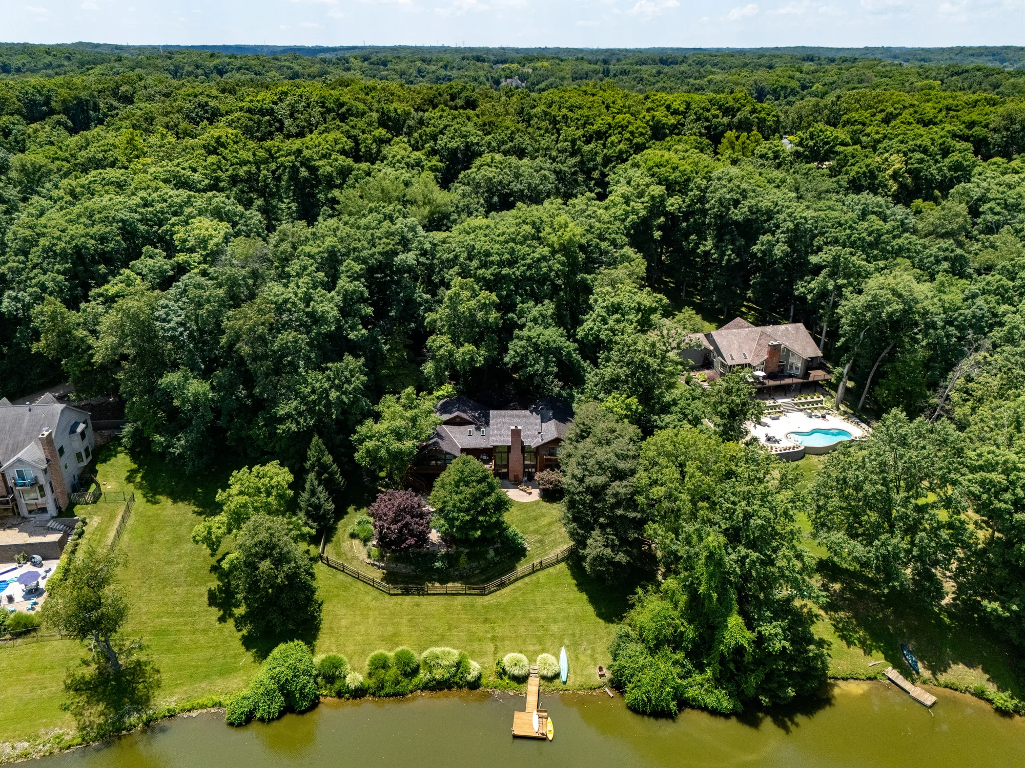 The lodge and its finished shake roof on the water, from the air