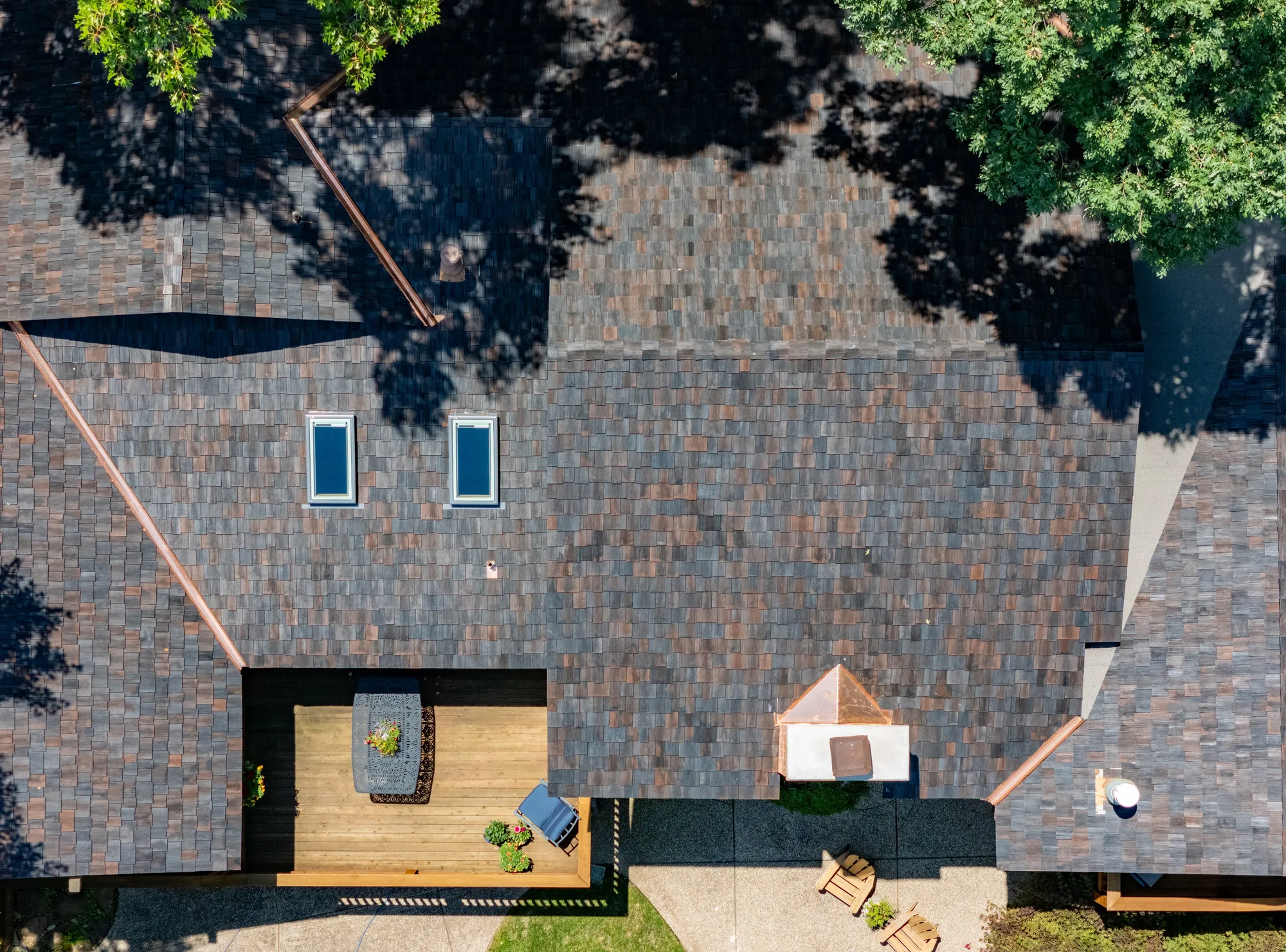Close aerial of a finished dimensional shake field on a wooded lodge