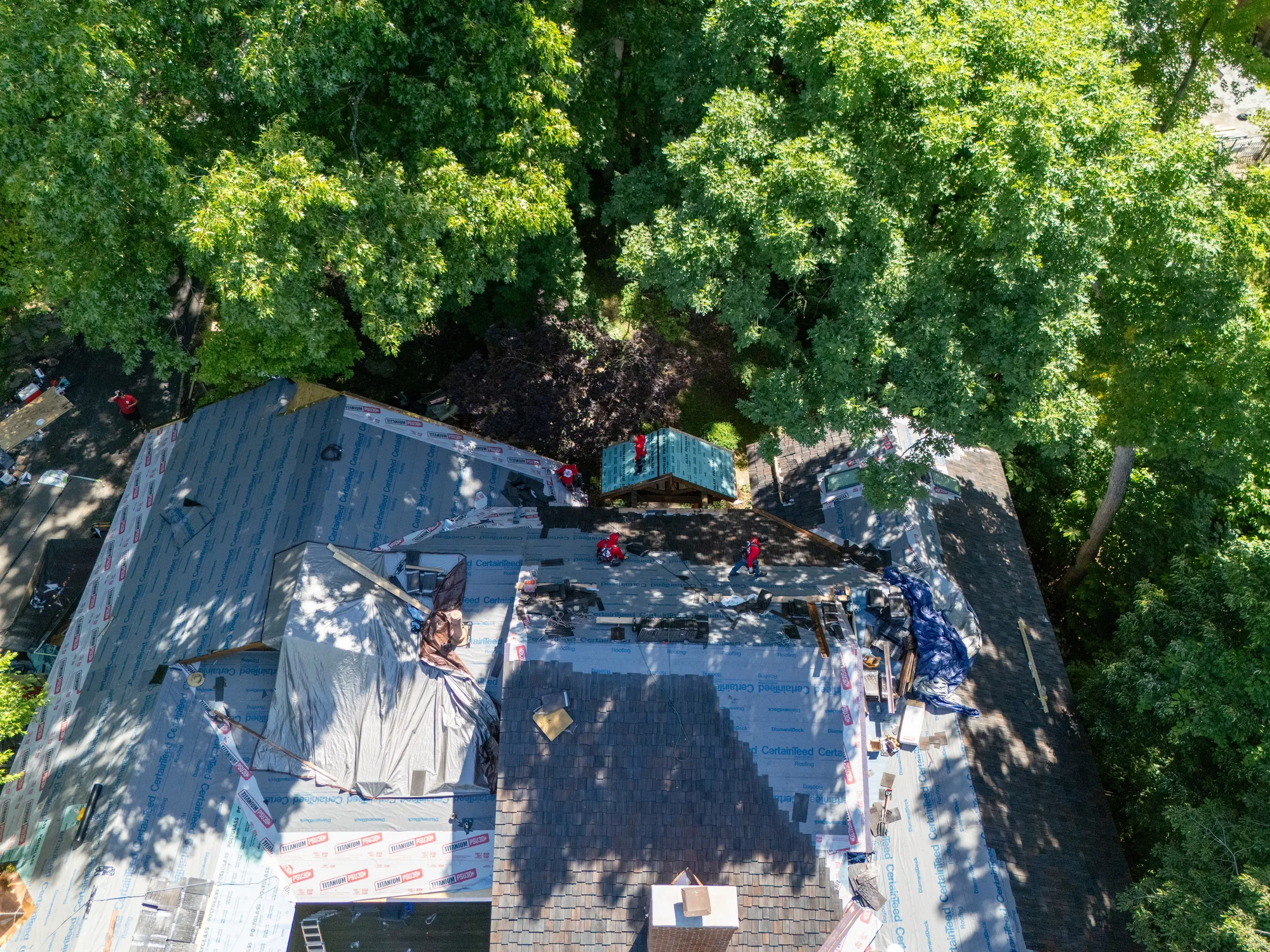 Donovan crew mid tear-off with the deck papered in and shake going on