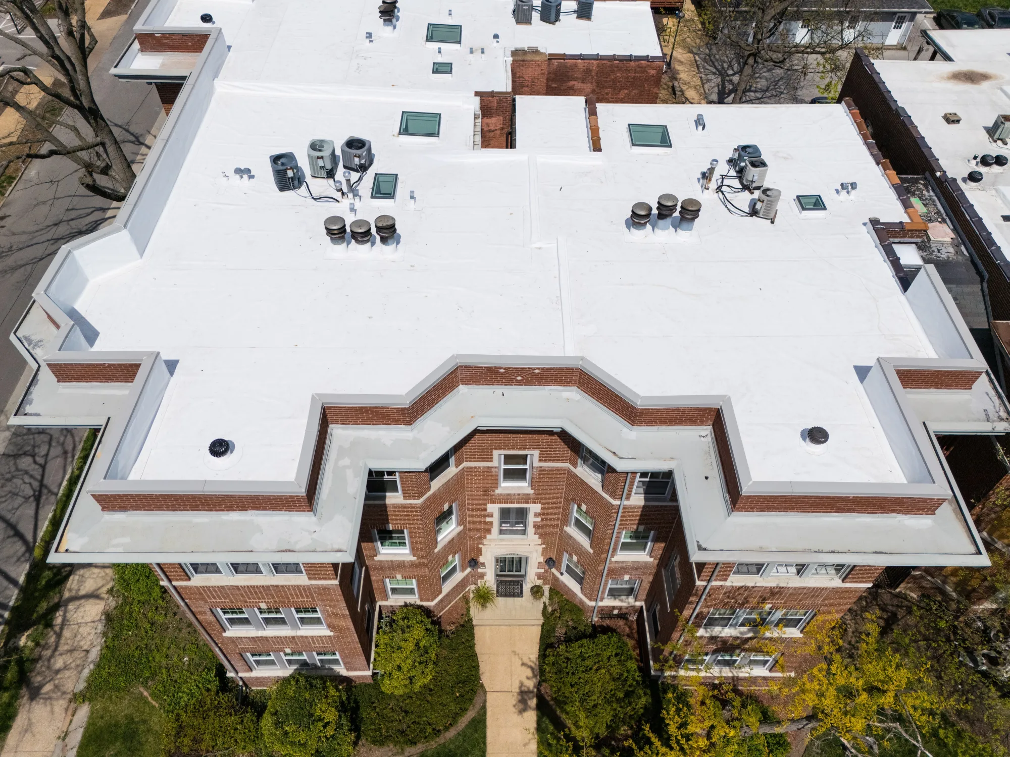 Aerial of a white single-ply membrane roof on a low-slope building