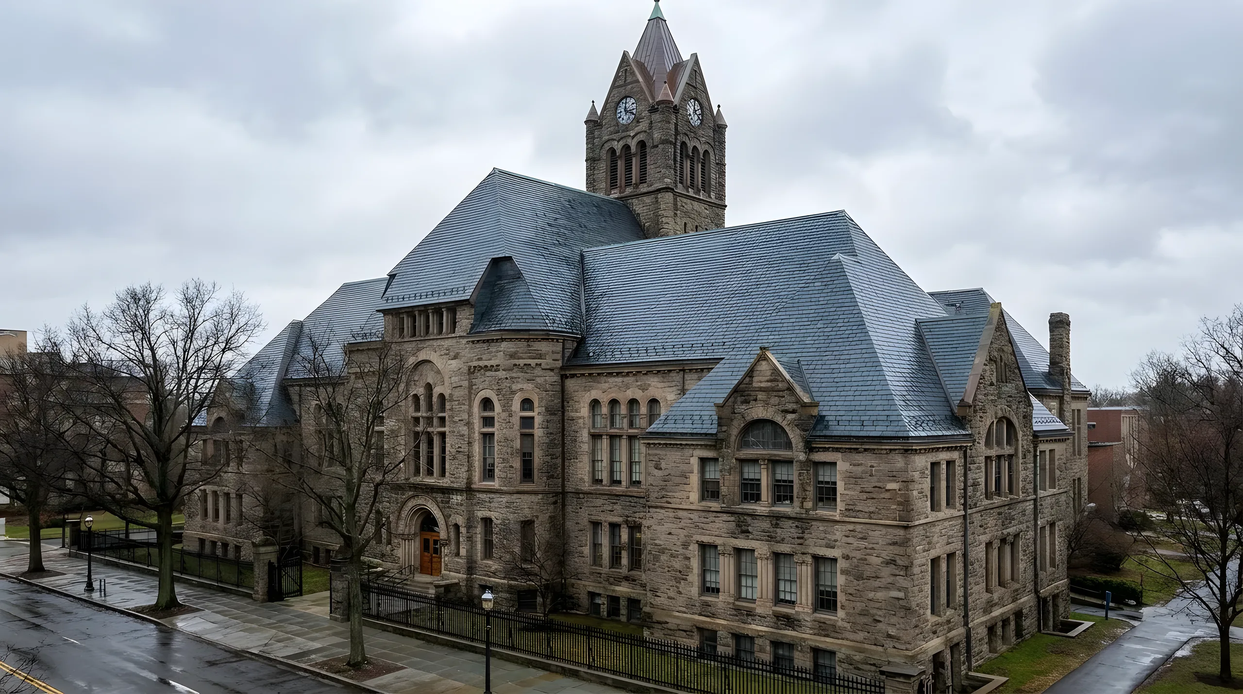 Large stone commercial building with a natural slate roof