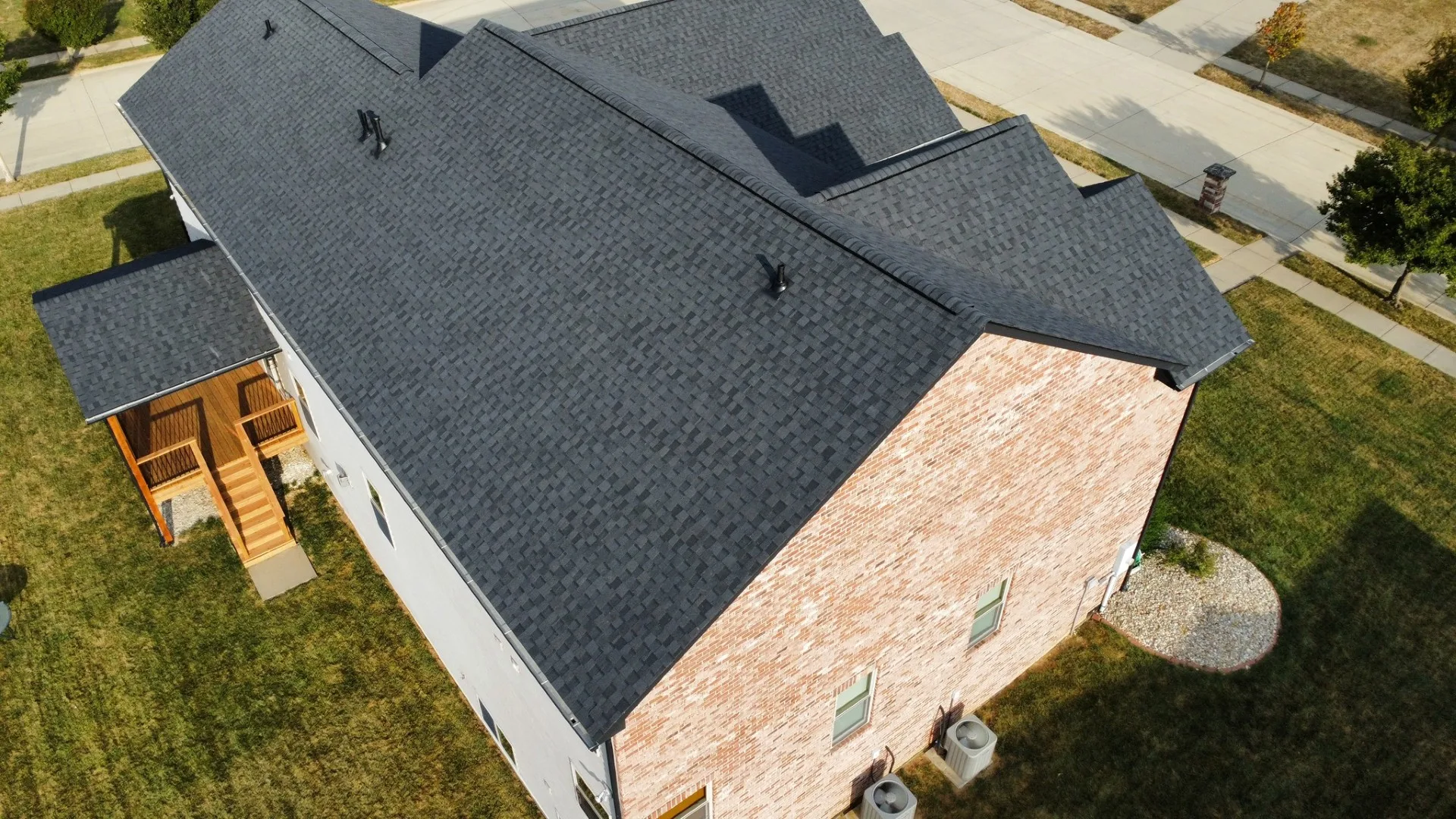 Crew assessing a storm-damaged roof from above before a claim