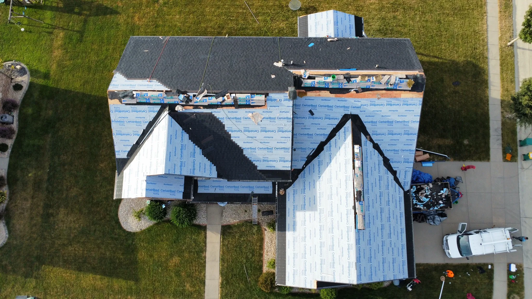 A roof mid tear-off after storm damage