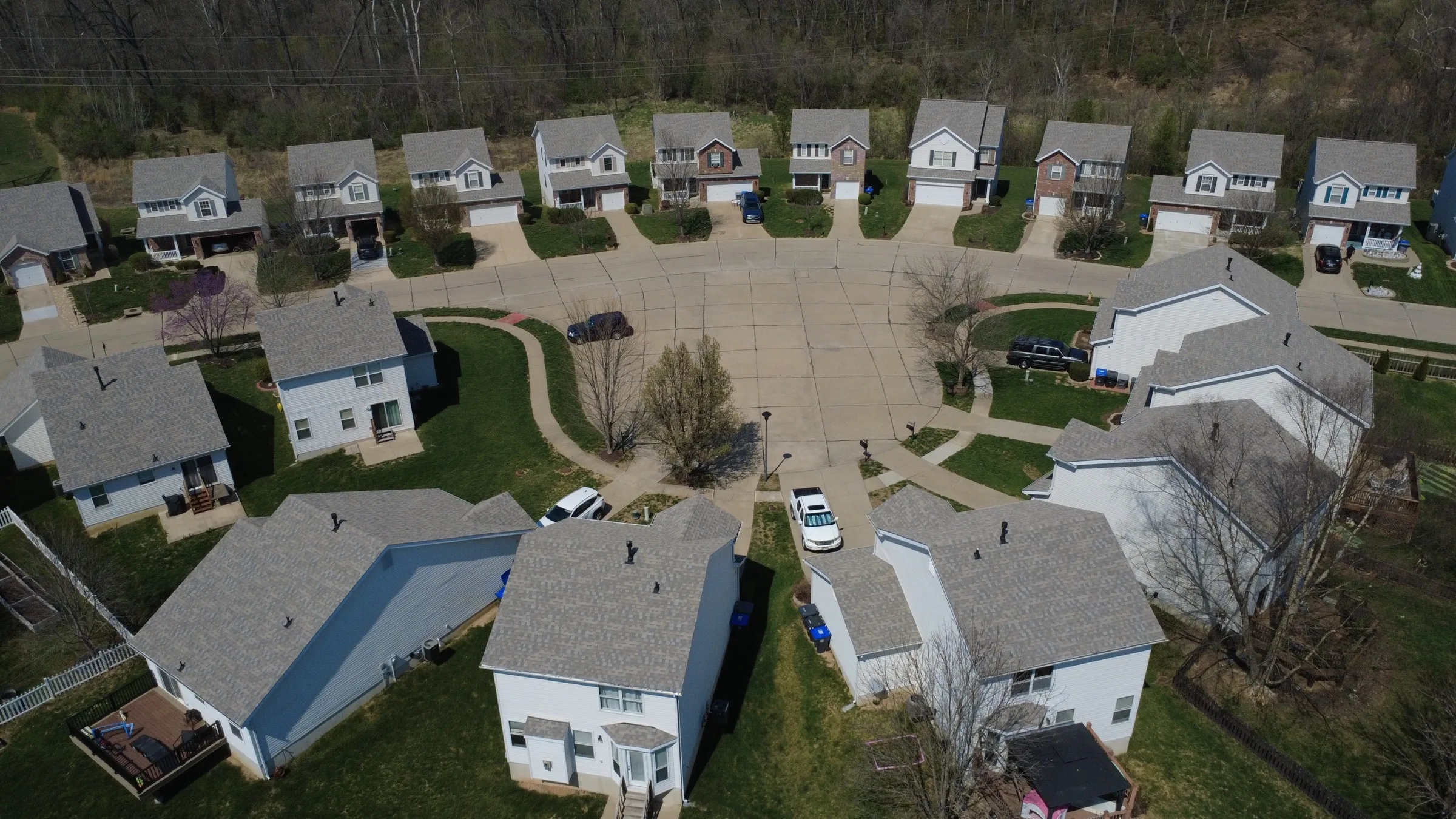 Drone view over a Hyland Green cul-de-sac ringed with new shingle roofs