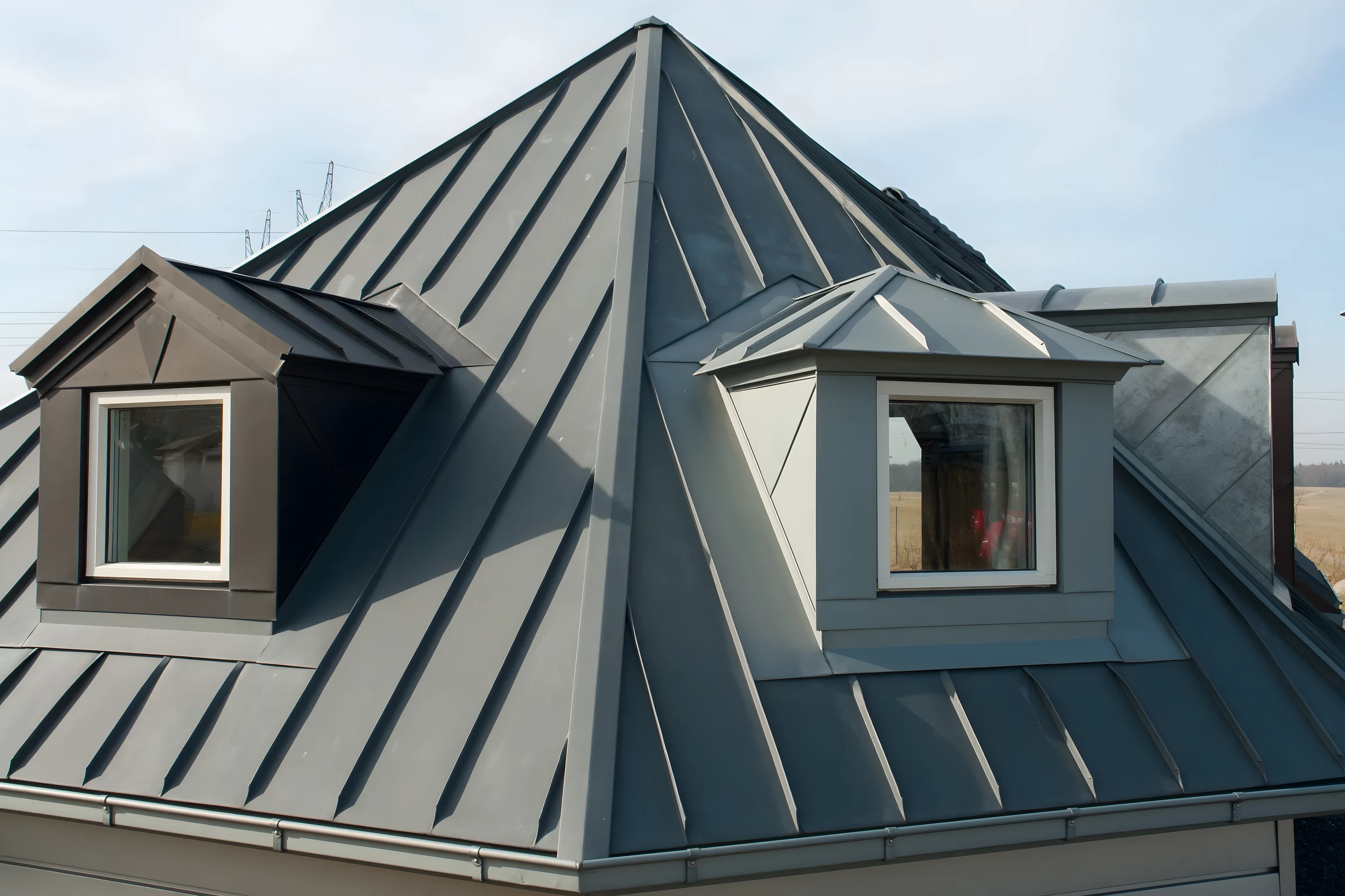 Finished standing-seam metal roof with dormers on a Kirkwood character home