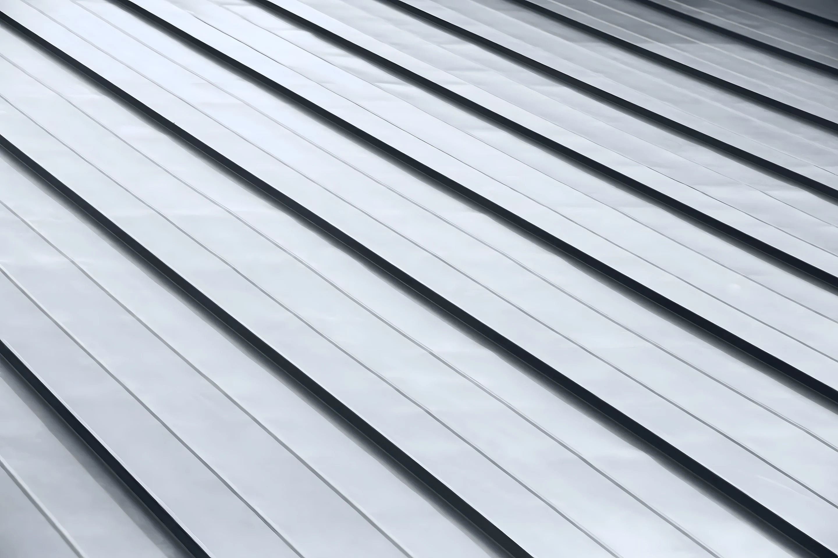 Close detail of the raised vertical seams on a metal roof panel