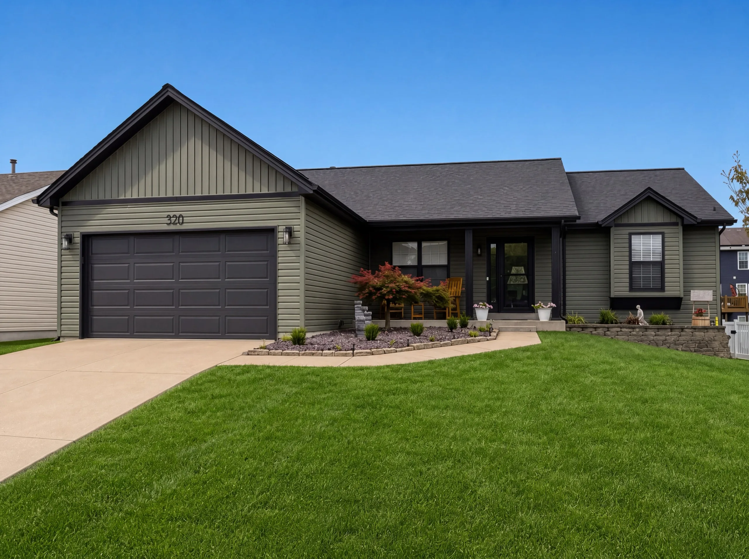 Ranch home with olive green vinyl lap siding and a dark architectural shingle roof