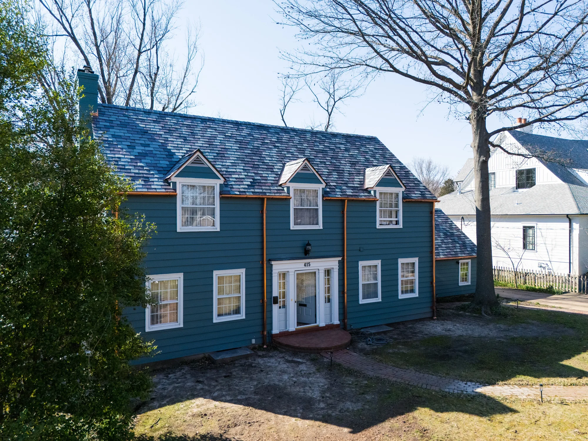 Elevated view of the rear slopes and dormers in variegated slate