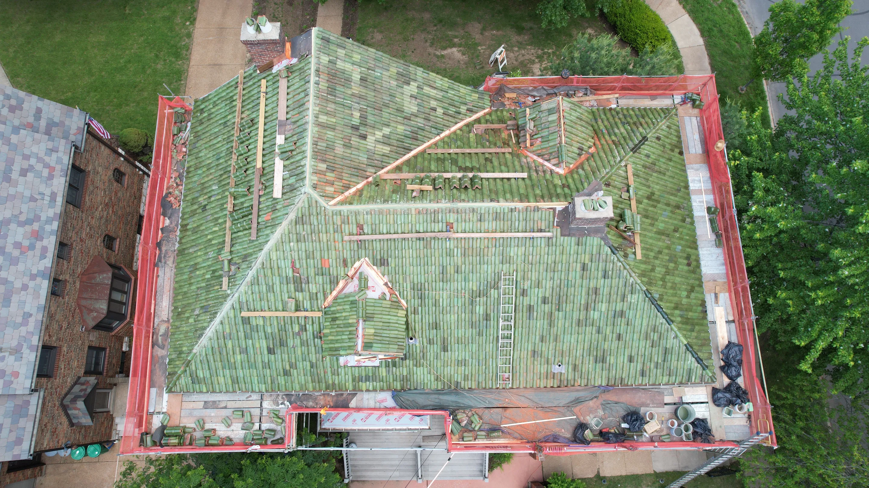Clay tile roof under installation with scaffolding