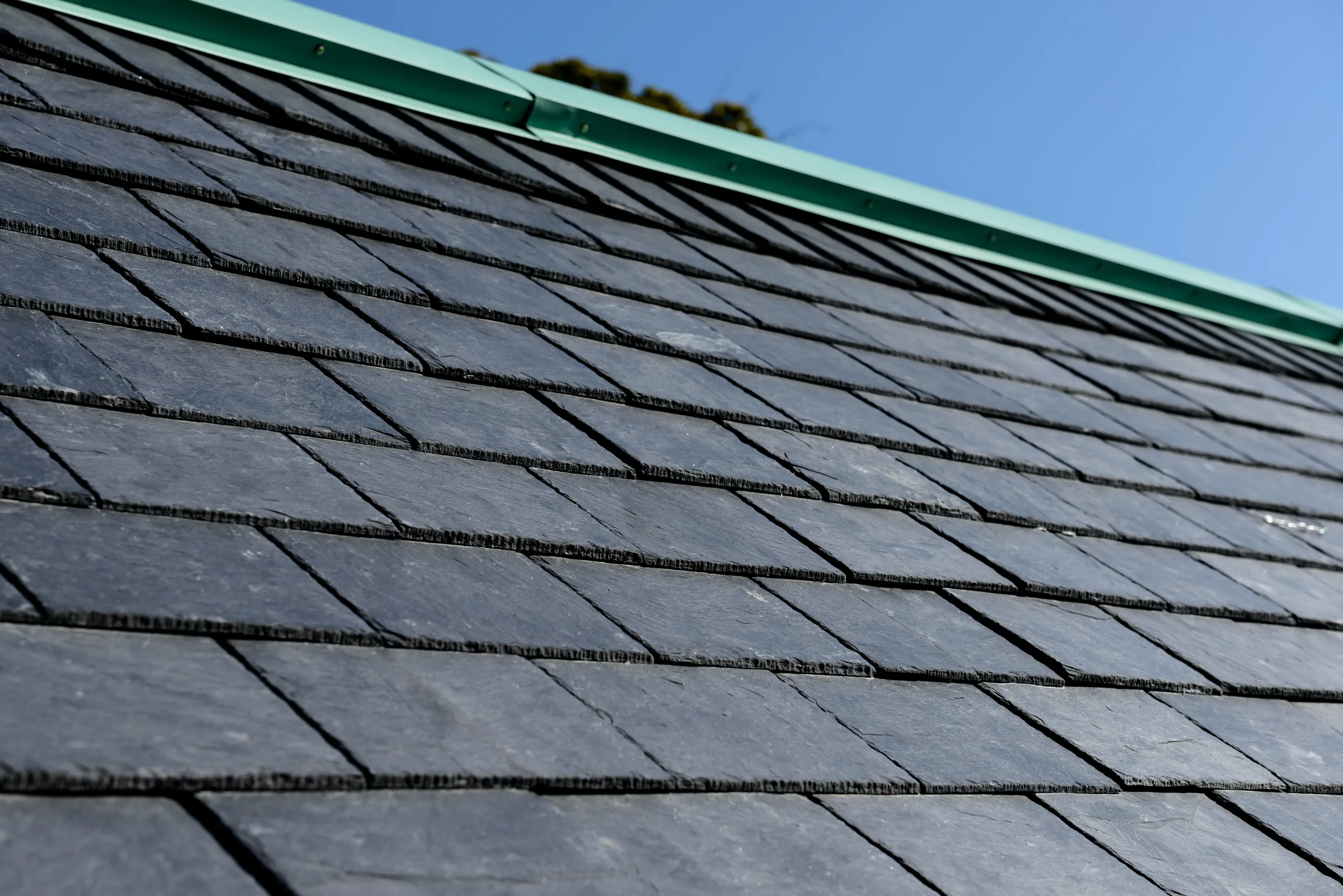 Natural slate roof with a copper drip edge