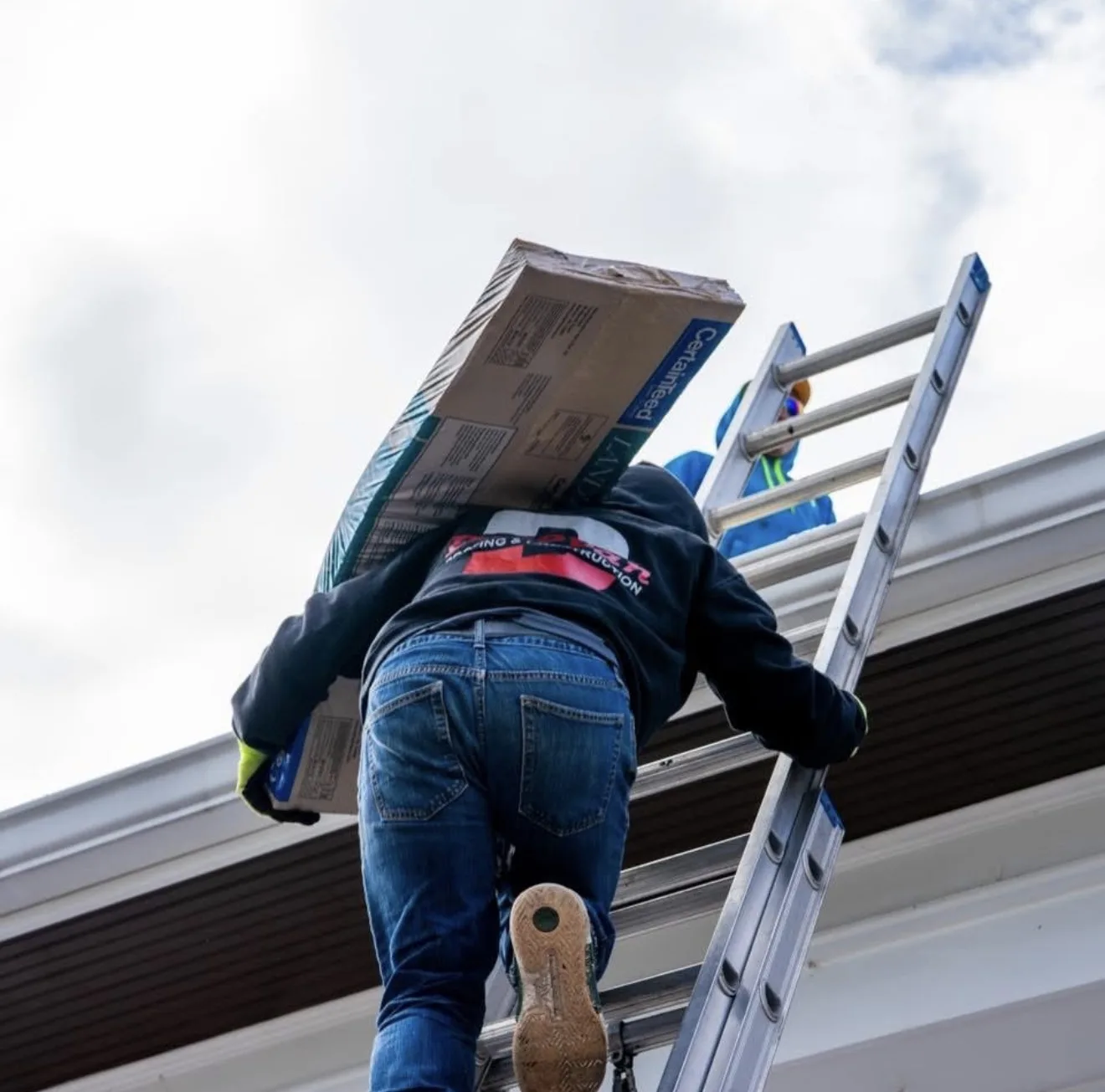 Ladder set against a house for a storm-damage roof inspection