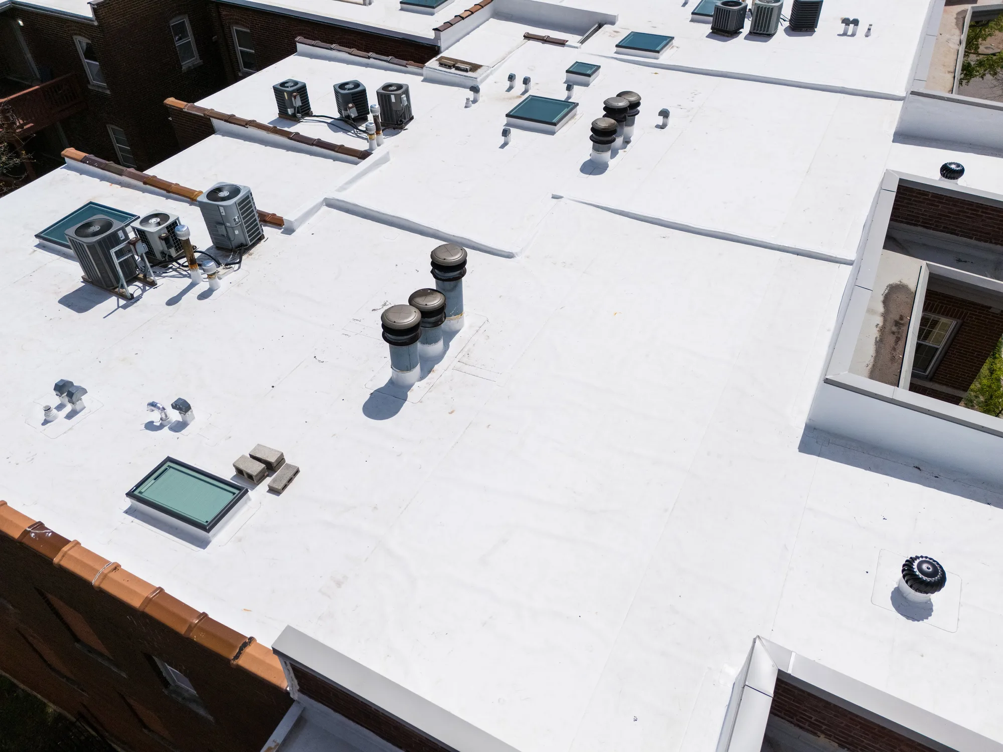 The broad membrane field with rooftop units flashed and sealed