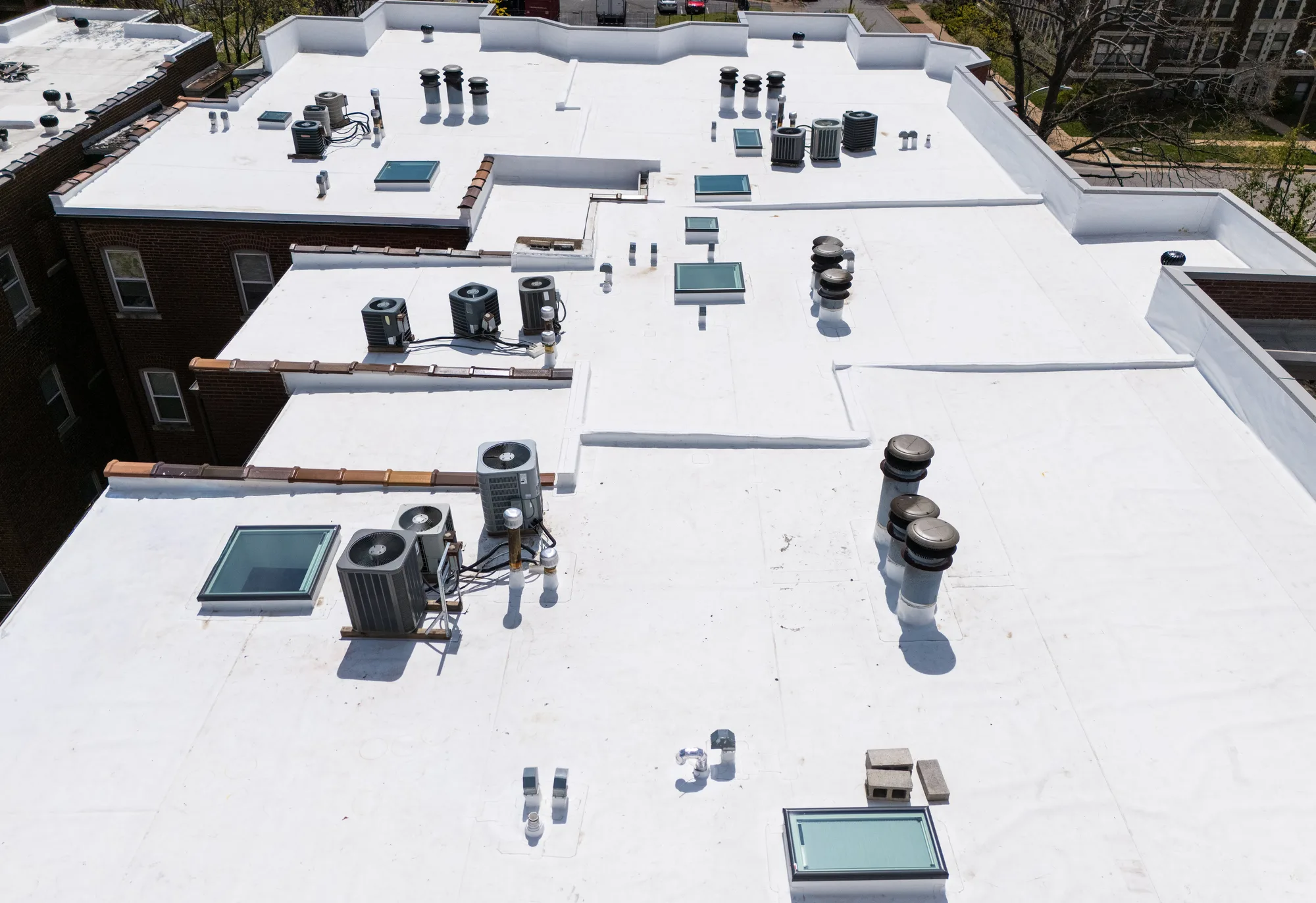 On the roof: membrane field, skylights, and flashed penetrations