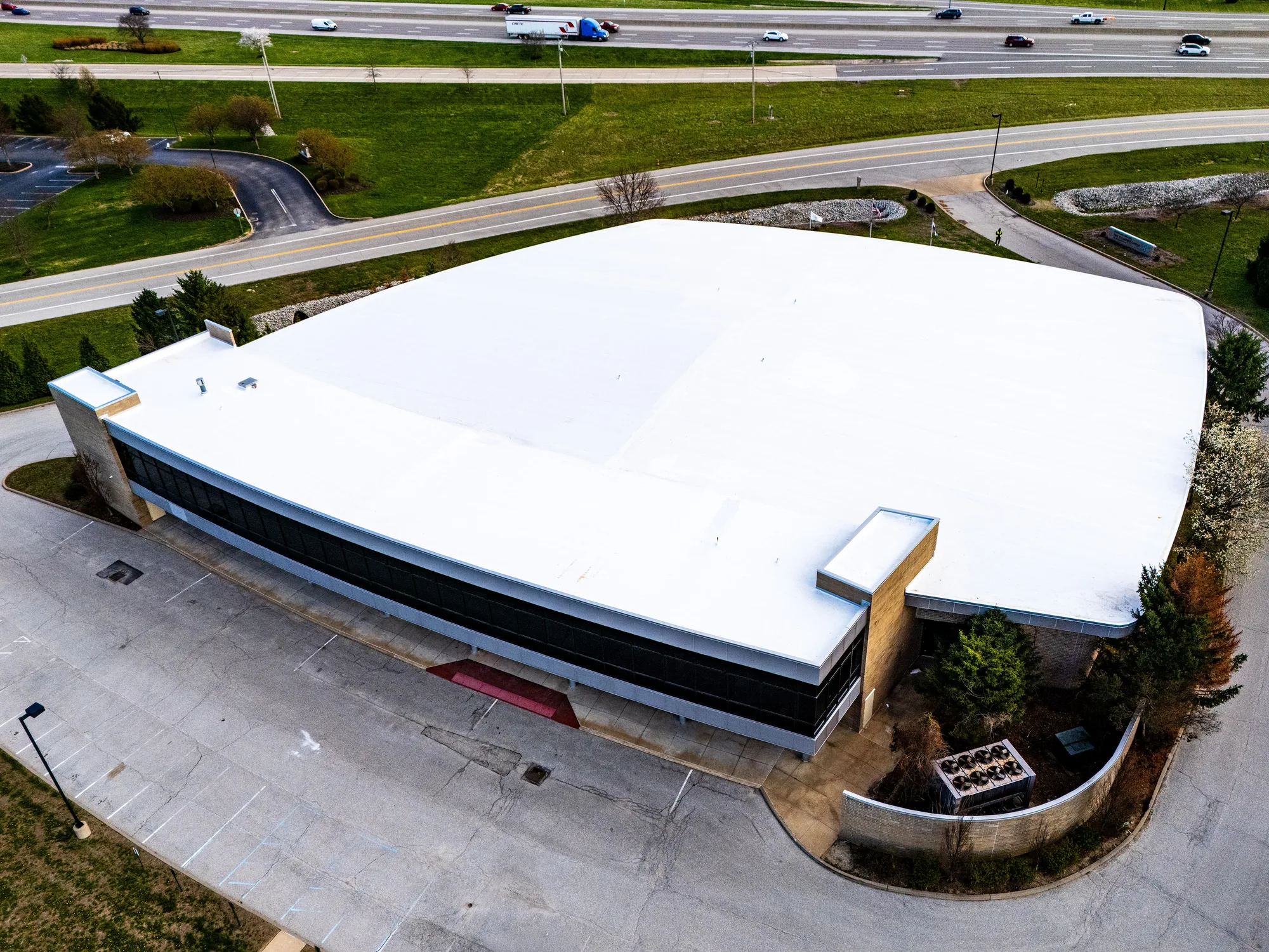 Curved commercial building with a finished white membrane roof
