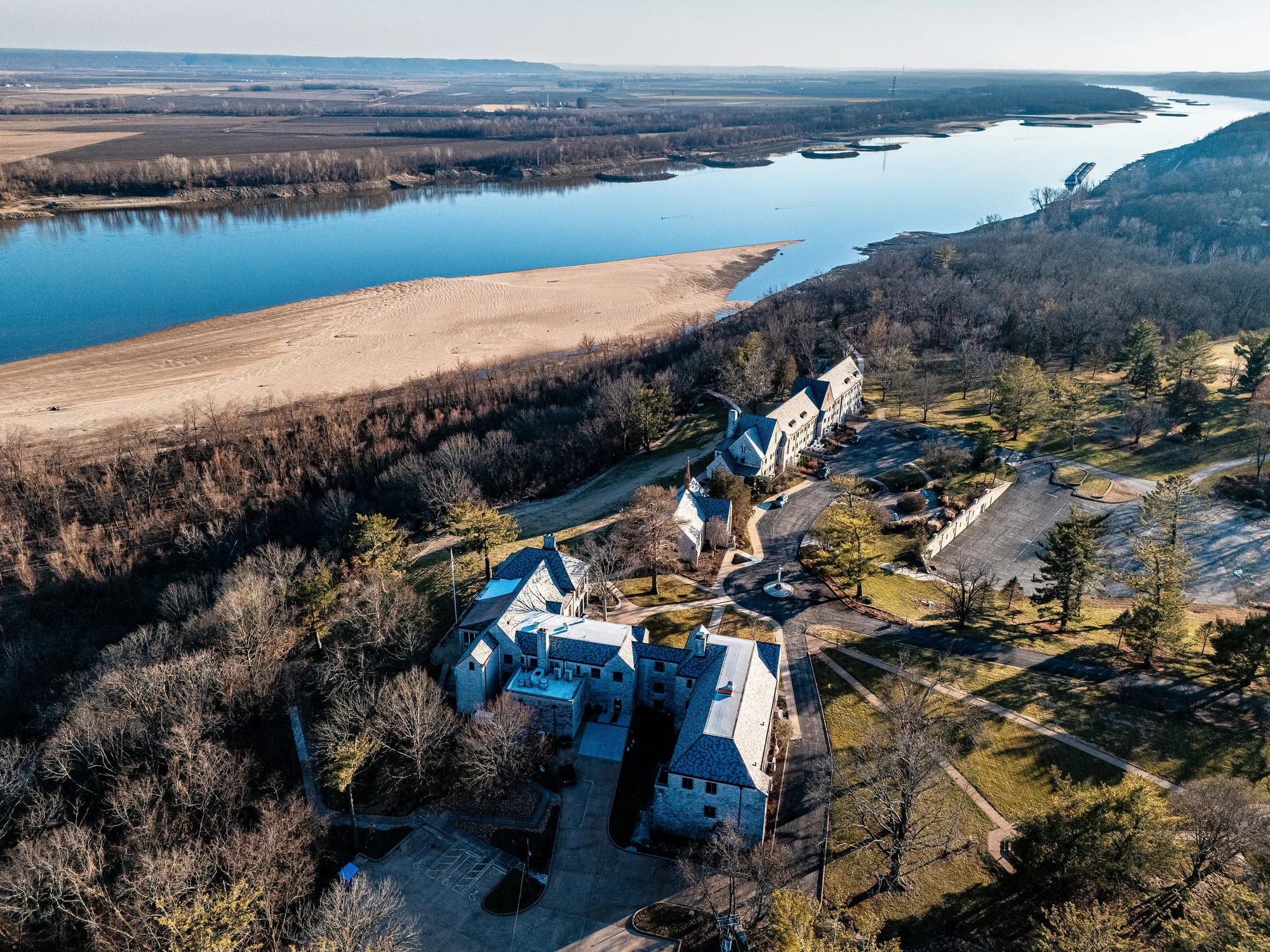Slate-roofed estate above a river bluff