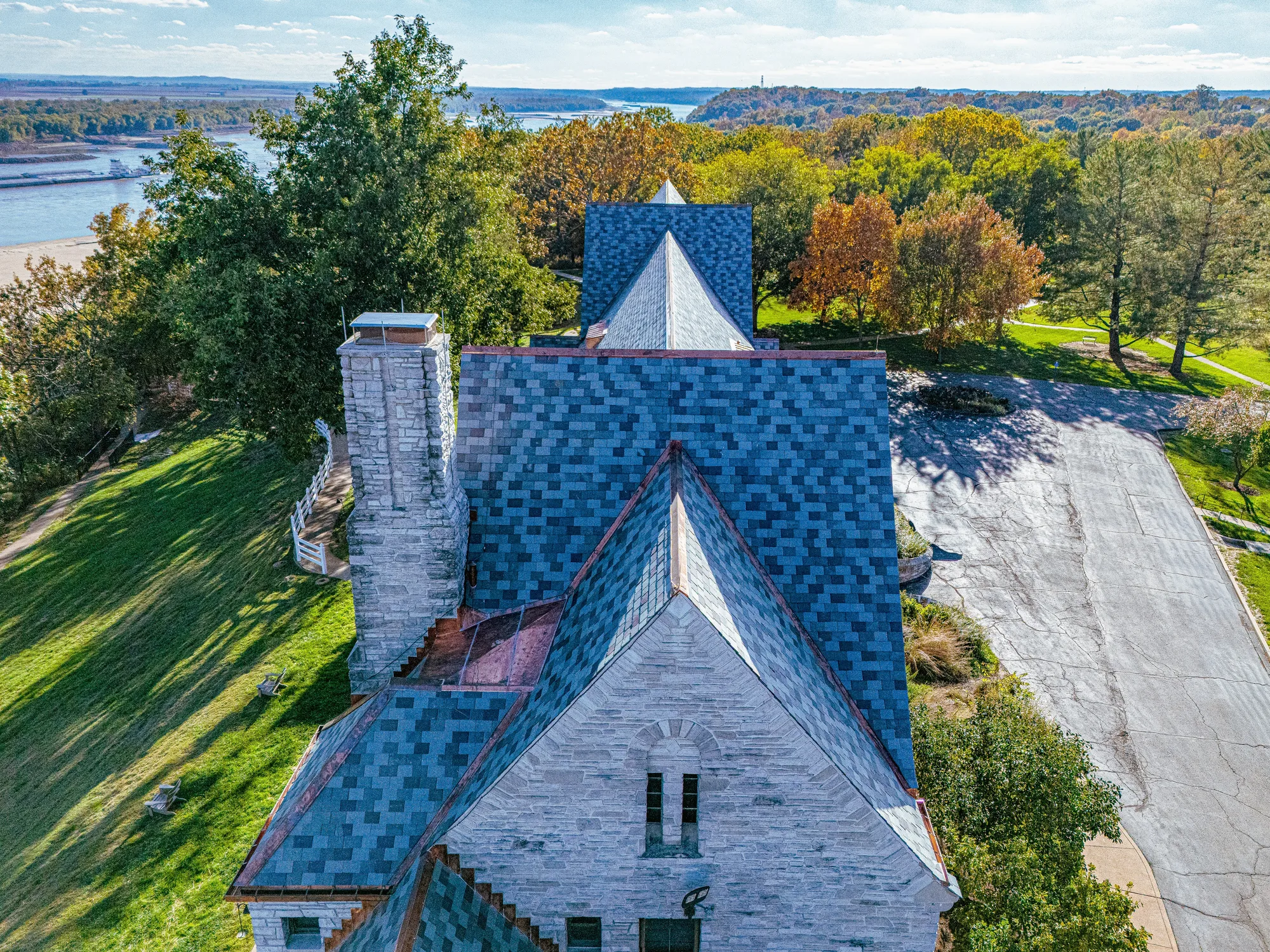 The slated chapel in fall color above the river